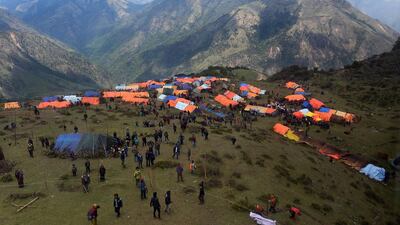 Nepalese villagers walk near their makeshifts tents at Laprak village in Gorkha district of Nepal on May 4, 2015. Sajjad Hussain / AFP