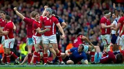 Wales players celebrate at the final whistle after their 16-9 victory.
