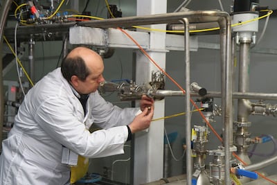 In this photo taken on January 20, 2014 an unidentified International Atomic Energy Agency (IAEA) inspector disconnects the connections between the twin cascades for 20 percent uranium production at nuclear power plant of Natanz. AFP