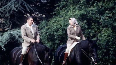 Queen Elizabeth riding Burmese alongside US President Ronald Reagan in the grounds of Windsor Castle during his state visit in 1982. Getty Images