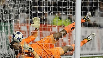 Heurelho Gomes tries his best to stop a Cristiano Ronaldo shot from going into the net, which sealed the Spanish club's passage into the semi-finals of the Champions League.