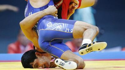 Turkmenistan’s Shermet Permanov (red) fights Japan’s Tsutomu Fujimura in their men’s Greco-Roman 71kg bronze medal wrestling match at Dowon Gymnasium during the 2014 Asian Games in Incheon. Issei Kato / Reuters