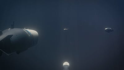 Three drone torpedoes zone in on a submarine in a video projection. Photo: Naval Group