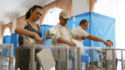 People cast their ballots during presidential vote at a polling station in Kiev. Gleb Garanich/Reuters