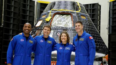 Astronauts for Nasa's Artemis 2 mission stand in front of their Orion crew capsule at the Kennedy Space Centre in Cape Canaveral, Florida. Reuters