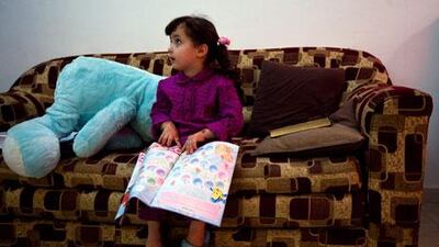 Leen Omar, 3, plays in her home in Abu Dhabi. Apart from her birth certificate, she has no legal documents.