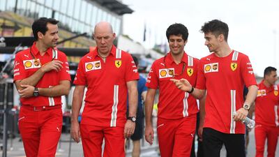 Ferrari's Monegasque driver Charles Leclerc (front R) walks down pit lane with team members at the Albert Park circuit ahead of the Formula One Australian Grand Prix in Melbourne. AFP