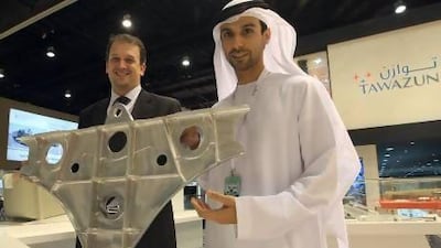 Majed Saif al Shamsi, sales and account manager, defence unit, and Vincent Mohni, senior manager-operations of Tawazun Precision Industries, TPI, with a display at Idex. Ravindranath K / The National