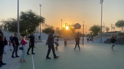 O'Neale on the court with some fans as the sun was setting.
