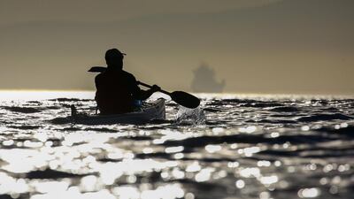 A man kayaks off the coast of Cape Town, South Africa. Nic Bothma / EPA
