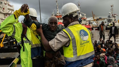 People from the town of Buzi are helped off a boat at Beira Port after being rescued in Beira, Mozambique. Getty Images