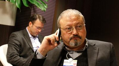 Saudi journalist Jamal Khashoggi speaks on his cellphone at the World Economic Forum in Davos, Switzerland. AP, File