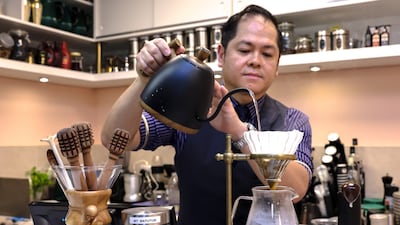 A barista prepares a Filipino signature roast coffee bean called Mount Matutum. A study has found that morning coffee drinkers have a lower risk of heart disease. Victor Besa / The National