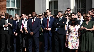 Deputy Prime Minister David Lammy waits for Mr Starmer's statement with members of Downing Street staff. AFP
