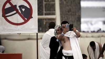 Pilgrims pose for a selfie during the "Jamarat" ritual in Mina in 2014. Mohammed Al Shaikh / AFP