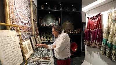 ‘It’s terrific:’ a visitor takes a closer look at the antiques displayed at the Art Souq, a unique event during Ramadan, at the Etihad Modern Art Gallery in Abu Dhabi. Satish Kumar / The Nationa
