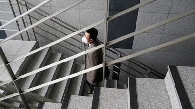 Park Hyun, a professor of Pusan National University Park Hyun who used to be a coronavirus patient, walks up the stairs at Pusan National University in Busan. Reuters