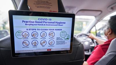 A guide to practising good personal hygiene is displayed to passengers in a taxi in Singapore. Bloomberg