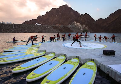 A yoga stand-up paddle training session during Dubai Stand-up Paddle. Victor Besa / The National