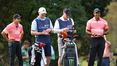 Tiger Woods and Charlie Woods with caddies Joe LaCava and Joe LaCava Jr on the sixth green. AFP