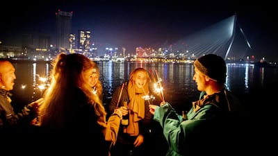 Revellers celebrated on the Erasmus Bridge in Rotterdam. Selling, owning, and lighting fireworks was prohibited during New Years in The Netherlands this year. EPA