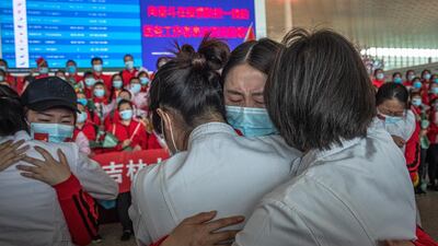 Medical workers from The First Bethune Hospital of Jilin University hug their Wuhan colleagues at the airport as they prepare to leave after the lockdown was lifted, in Wuhan, China. EPA