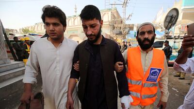 Rescue workers help an injured man in the aftermath of an explosion at an Islamic seminary in Peshawar, Pakistan. EPA