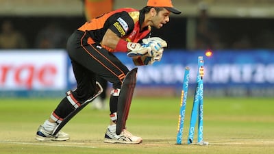 Sunrisers Hyderabad wicketkeeper Naman Ojha, right, successfully runs out Rising Pune Supergiants batsman Usman Khawaja. Noah Seelam / AFP