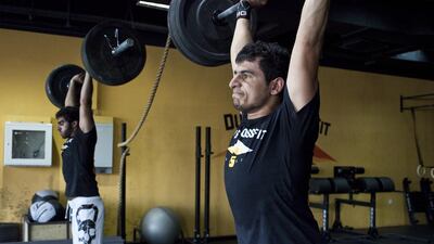 Saud Saif Al Shamsi, right, here training with his cousin Ali bin Zayed, nearly did not not make it to the Asian CrossFit regionals in South Korea because of a broken finger. Antonie Robertson / The National