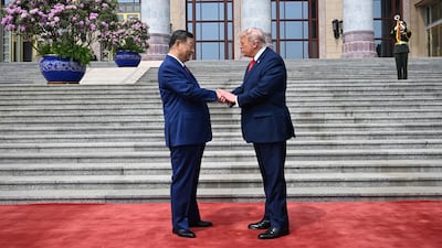 President Trump shakes hands with President Xi at the Great Hall of the People in Beijing. AFP