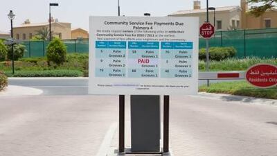 A sign posted outside of the entrance to Palmera 4 in Arabian Ranches lists the villa numbers who have not paid their community service fees from 2010-2011.