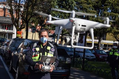 A drone pilot of the Civil Protection agency operates one of three drones supplied to the municipality of Opera, near Milan. The drones are used to monitor citizens' compliance with rules restricting movement amid a nationwide lockdown. EPA