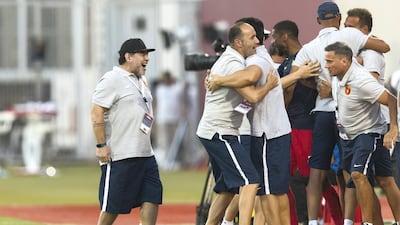 Diego Maradona, left, is hoisted in the air by Fujairah team manager Yousuf Abdullah after seeing his side take the lead against Al Orouba. Christopher Pike / The National