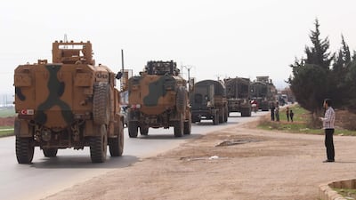 A Turkish military convoy drives near the Syrian town of Kefraya on the highway linking the northwestern Syrian province of Idlib to the Bab al Hawa border crossing with Turkey. AFP