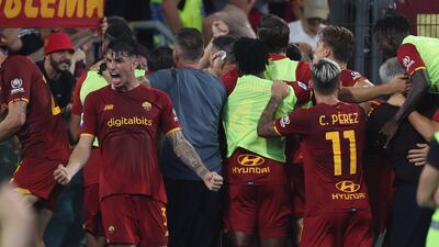 Roma players and coaching staff celebrate the late winner. Getty