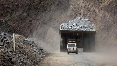 A safety vehicle follows a mining truck loaded with excavated kimberlite rock out of Jwaneng mine, operated by the Debswana Diamond Co, a joint venture between De Beers and Botswana's government, in Jwaneng, Botswana. Chris Ratcliffe / Bloomberg