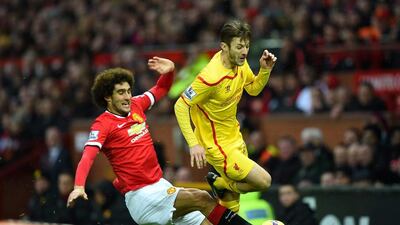 Marouane Fellaini of Manchester United challenges Adam Lallana of Liverpool during their Premier League match on Sunday. Shaun Botterill / Getty Images