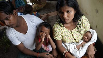 Chaw Shaw Chaw Thee, 20, sits with her newborn baby, her husband and their young son at a shelter for refugees in Sittwe, Myanmar on September 22, 2017. She fears that 23 members of her family are dead after Myanmar's army said it had discovered a mass grave containing the bodies of 28 Hindus, including women and children, in Rakhine state. Aidan Jones / AFP