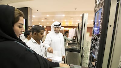 Passengers pass through the now compulsory E-Border gate, part of the smart travel system, at the Abu Dhabi International Airport. Christopher Pike / The National