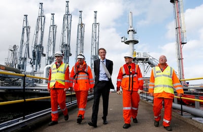 Ineos founder and chief executive, Jim Ratcliffe, centre, at the Grangemouth shale gas terminal in Scotland, Mr Ratcliffe said a prolonged winter could 'shut down industry'. Reuters