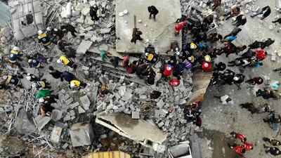 Members of the White Helmets search through the rubble of a building at the site of a regime airstrike on Idlib. AFP