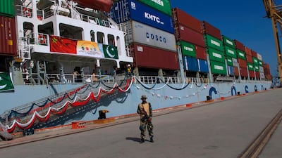 A Pakistan Navy soldier stands guard while a loaded Chinese ship prepares to depart, at Gwadar port. There are major plans afoot to evelop the facility into a major trade, tourism and residential hub. Muhammad Yousuf/AP