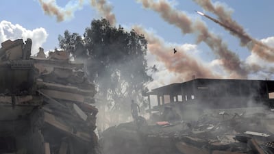 Rockets are fired from the Gaza Strip toward Israel over destroyed buildings following Israeli airstrikes on Gaza City. AP Photo