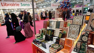Visitors walk past a bookseller displaying copies of the Quran during the 32nd Annual Meeting of France's Muslims, at Le Bourget Exhibition Centre, north of Paris, on April 3, 2015. Thomas Samson/AFP Photo