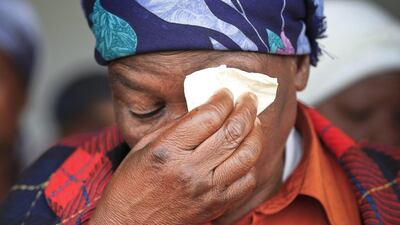 An elderly resident of Qunu wipes away tears as she watches live broadcast of Mandela's funeral. Dai Kurokawa / EPA