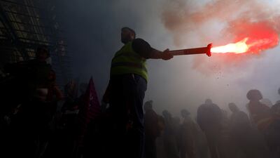 A striking worker brandishes a flare in Nice. Reuters