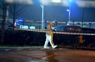 A forensics officer at the Omagh sports centre where an off-duty police officer was shot. PA