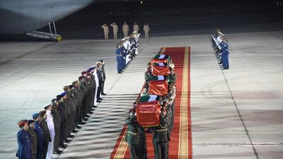 The bodies of Ahmed Khamis Al Hammadi, Mohammed Khalfan Al Seyabi, Ali Khamis Al Ketbi, and Yousef Salem Al Kaabi are carried into Al Bateen Airport.