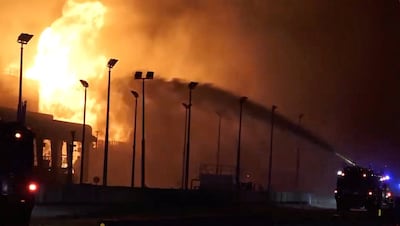 Firefighters battle a blaze at fuel tanks near Bahrain's airport on March 12. The island nation has effectively shut down its airport due to Iranian bombing. Photo: Bahrain Information Ministry / Reuters
