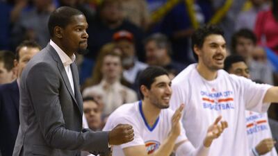 Injured Oklahoma City Thunder forward Kevin Durant, left, is there for his teammates emotionally, and that will have to do as the team has decided to shut him down for the remainder of the season. Sue Ogrocki / AP Photo